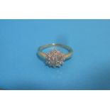 An 18ct gold diamond daisy cluster ring, approx. size O