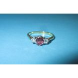 An 18ct gold diamond and ruby ring, approx. size N