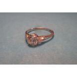 An art deco platinum & diamond ring, the central stone measuring approx. 6.6mm across the girdle,