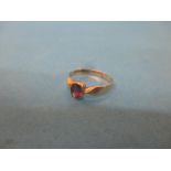 A 9ct gold ring with central garnet, approx. size M