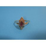 An unmarked gold ring set with a central ruby flanked by diamonds, approx. size P ½