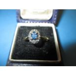 An 18ct gold diamond and sapphire cluster ring, approx. size P