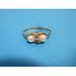 A 9ct gold diamond and pearl ring, approx. size N