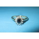 A 9ct gold diamond and sapphire cluster ring, approx. size P ½