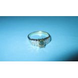 An 18ct gold ring set with central aquamarine? And diamond flanked shoulders, approx. size N