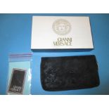 A boxed and un-used Gianni Versace evening purse with paperwork