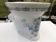 A ceramic blue & white transferware toilet with fl