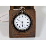 A silver pocket watch with 19thC. wooden stand