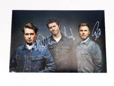 A hand signed Take That photograph with three memb