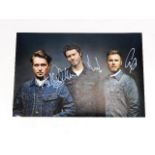 A hand signed Take That photograph with three memb