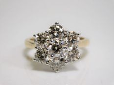 A large 18ct gold seven stone diamond cluster ring