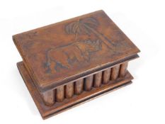 A walnut box with carved rhino detail