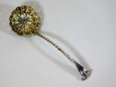 A silver sifter with gilt bowl