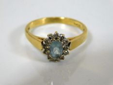 An 18ct gold ring set with aqua & diamond