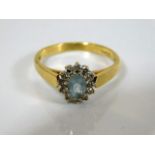 An 18ct gold ring set with aqua & diamond