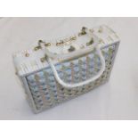 A woven ladies case with lucite style handles