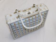 A woven ladies case with lucite style handles
