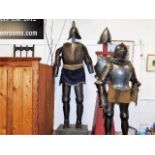 A 19thC. adults suit of armour mounted on oak stan