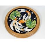A Moorcroft pottery carp & lily framed plaque by R