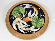 A Moorcroft pottery carp & lily framed plaque by R