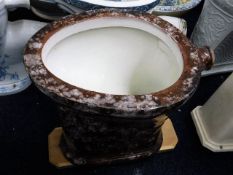 An early 20thC. slipware style ceramic toilet, two cracks to exterior