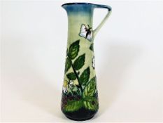 A Moorcroft pottery jug approx. 9.5in with floral