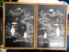 A pair of Oriental wooden pictures with applied carved decor