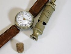 A WW1 wrist watch, a 1915 military whistle & a lea