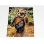 A hand signed Warwick Davis photograph on set of S