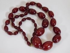 An early 20thC. set of cherry amber bakelite beads