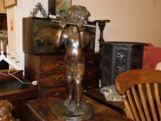 A c.1900 bronze figure of a young boy playing the