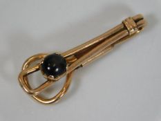 A 9ct rose gold tie clip set with star sapphire
