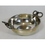 A silver wine tasting bowl with decorative rope ha