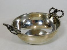 A silver wine tasting bowl with decorative rope ha