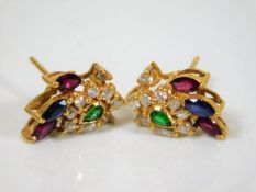 A pair of 21ct gold stud earrings set with diamond