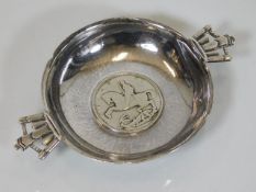 A silver wine taster bowl