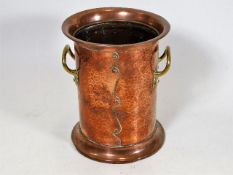 An arts & crafts style copper & brass wine holder