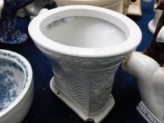 A Victorian ceramic toilet with relief neo-classical decor, chip to base