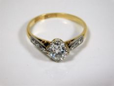 An 18ct gold ring set with old cut main diamond of