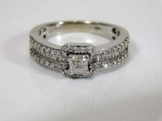 An 18ct white gold & diamond encrusted ring, the c