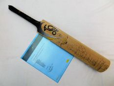 A signed cricket bat bearing autographs of the Aus