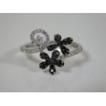 A 9ct black & white diamond encrusted ring approx. 0.6cts