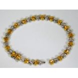 An 18ct gold two tone bracelet with diamond set wh