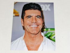 A hand signed Simon Cowell photograph as acquired