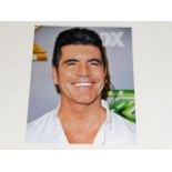 A hand signed Simon Cowell photograph as acquired