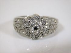 An 18ct art deco style white gold ring 6g encrusted with diamonds the centre stone being approx. 0.2