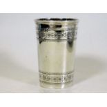 A silver beaker with chased decor to top & bottom