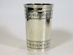 A silver beaker with chased decor to top & bottom