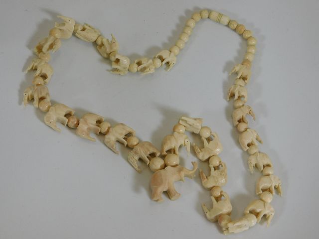 A carved bone elephant necklace