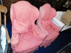 A pair of early 20thC. upholstered wing back chair